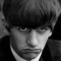 Ringo Starr with a sad expression on his face in black & white.