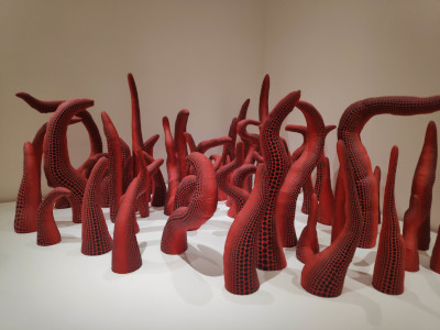 Giant red tentacles with regularly-spaced black dots on them.