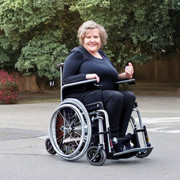 A woman in a normal wheelchair.